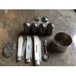 A set of four American sterling silver barrel shaped pepperpots; a hallmarked silver napkin ring;