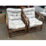 A pair of cane armchairs with loose button upholstered cushions. (2)