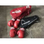 Two pairs of red leather Lonsdale boxing gloves; a cased pair of modern Head titanium tennis