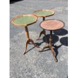 A pair of scalloped top circular wine tables with green gilt tooled skivers, supported on turned