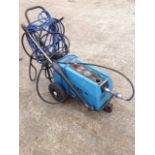 A Kew electric pressure washer on trolley stand, with lance, long cable, detergent mixing line, etc.