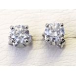 A pair of 18ct gold stud diamond earrings, the round diamonds with a total weight of just over a