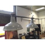 A pair of industrial style hanging lights, the enamelled shades under convex glass with chrome