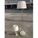 A brass standard lamp with matching tablelamp, having circular bases supporting columns with