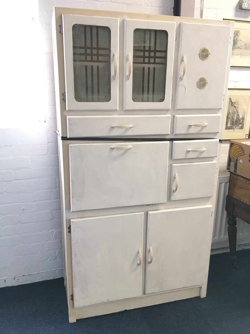 A painted 1960s kitchen cabinet, with acid etched glazed doors, drawers, cupboards, a baize lined