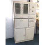 A painted 1960s kitchen cabinet, with acid etched glazed doors, drawers, cupboards, a baize lined