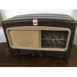 A Cossor Melody Maker valve radio, in brown bakelite case with glass dial.