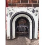 A painted Victorian cast iron fire insert, with bead moulded arched frames around the aperture,