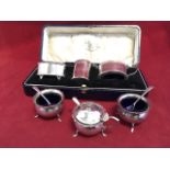A cased three-piece hallmarked silver cruet set of oval bead moulded form - Chester, 1923; and