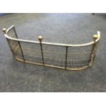 A small nineteenth century 'D' shaped fender with grill panels to frame, surmounted by three brass