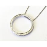 A 14ct gold diamond pendant, the circular ring set with baguette cut diamonds, mounted on an 18ct