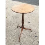 A nineteenth century mahogany wine table, the circular top with chequered stringing supported on a