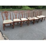 A set of six nineteenth century mahogany dining chairs, with arched backs above pierced splats,