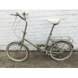 A 70s Raleigh Saffron bicycle, with sprung seat, gears, chain & mud guards, panier rack, etc.