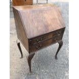 A small Georgian style mahogany bureau, the fallfront revealing an interior with pigeonholes and