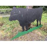 A large painted farm sign, cut from sheet metal, depicting a bull on field base.