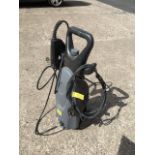 An electric pressure washer complete with lance.