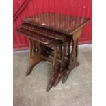 A nest of mahogany tables, with crossbanded tops on lyre supports with splayed legs. (3)