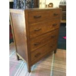 A 30s oak chest of four drawers mounted with rectangular handles, with panelled sides, raised on