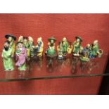 A collection of Chinese stoneware figures, the moustached men in various occupations glazed in