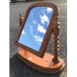 A Victorian mahogany dressing table mirror, the arched plate in cushion moulded frame supported on