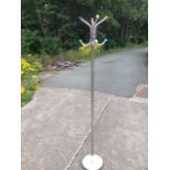 A 60s chrome coatstand with four hooks on column with circular weighted base, the pegs with coloured