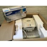 A boxed Samsung office printer, with spare toner cartridge, cables, instructions, etc. (A lot)