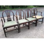 A set of four nineteenth century mahogany dining chairs with two carvers, having hooped rounded