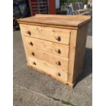 A pine chest with four long graduated knobbed drawers, supported on a plain plinth. (40in x 18in x