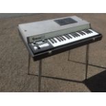 An Italian Gemini electric piano, the cased instrument on tapering chrome legs with three octave