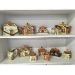 A collection of cottage ware by Price and Keele Street, Staffordshire, the handpainted thatched