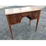 A nineteenth century mahogany dressing table with rectangular moulded top above an arched kneehole