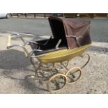 A 60s Silver Cross pram, the metal body with concertina hood and vinyl cover with chrome mounts,