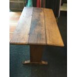 A late nineteenth century oak alter table, the rectangular top with rounded corners and two drop