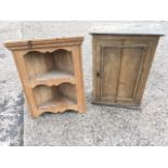 A French mahogany cupboard with panelled door; and a small pine open corner cupboard with shaped