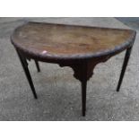 A nineteenth century 'D' shaped mahogany hall table, having leaf carved edge to top above frieze