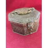 A nineteenth century octagonal brass & copper food box, overall embossed with foliate panels with