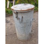 A large tubular galvanised bin with domed hinged lid, riveted with four carrying handles and mounted