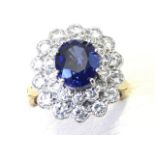 An 18ct yellow gold diamond & sapphire ring, the oval claw set sapphire of just over two-and-a-