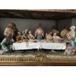 A large finely modelled Italian Capo-de-Monte centrepiece depicting The Last Supper, the apostles