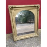 A Victorian gilt & gesso frame having scrolled corner mounts with later mirror plate.