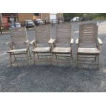 A set of four teak garden armchairs, with slatted backs & seats, all folding. (4)