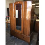 A 30s oak wardrobe, with bevelled mirror door framed by bowfronted panels with blind fretwork