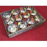 A boxed set of twelve Chinese tea bowls, glazed with circular butterfly medallions framed by