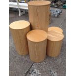 A set of five graduated tubular stands with round oak covers. (5)