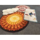 A circular hand-knotted wool rug in the form of a sunflower; another handmade rug with