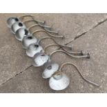 A set of eight brass wall-lights, the bowl shaped shades with rolled rims on tubular scrolled
