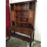 A mahogany dresser, the open delft rack with two panelled cupboards framing shelves, the base with