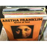 A box of vinyl LP records including Aretha Franklin, Buddy Holly, Simple Minds, Elvis, UB40,