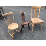 A spindleback chair with circular seat raised on angled legs; a singed pine campaign style chair
